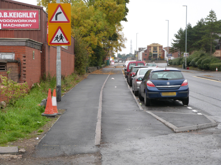 Superhighway passes behind parking spaces